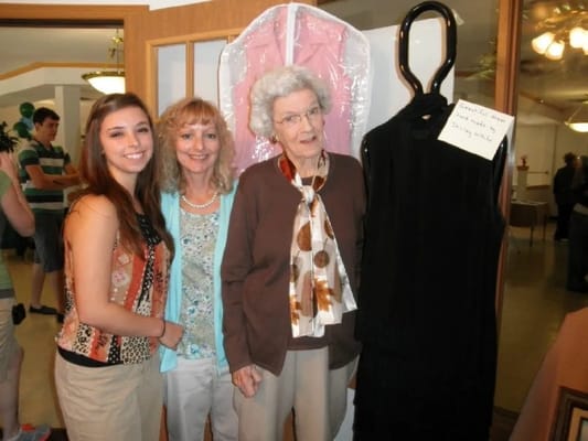 Residents and staff at a community event with clothing displays
