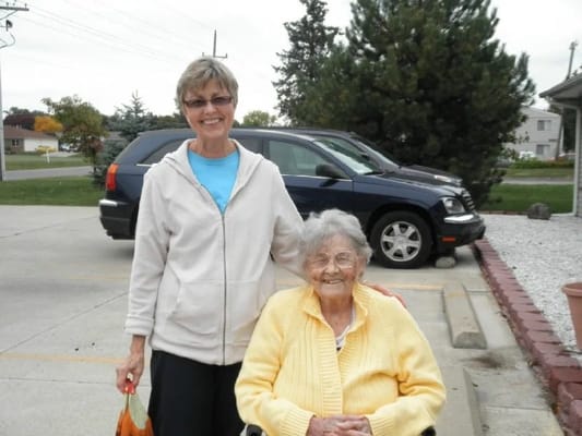 A staff member assisting a resident outdoors