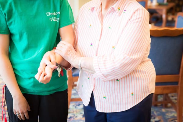 Staff member assisting a resident indoors