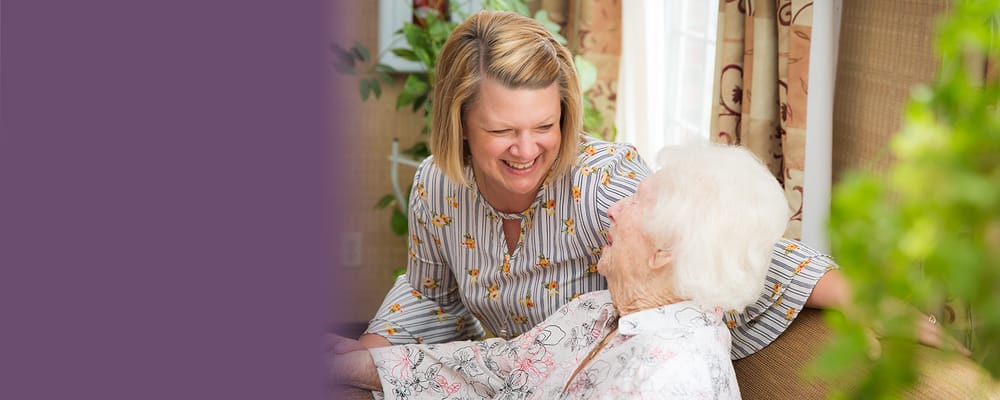 Staff member interacting joyfully with a resident