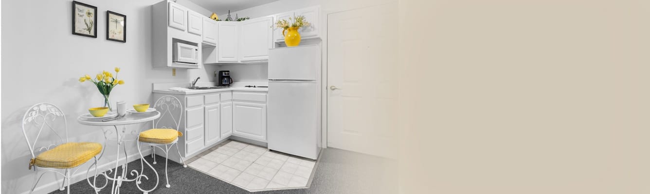 Brightened kitchen area with table and chairs