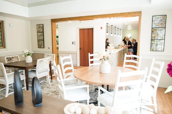 Bright common area with tables and residents