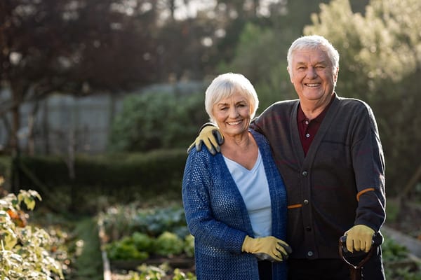 Two residents smiling in a community garden