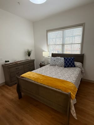 Cozy resident bedroom with wooden furniture and decor