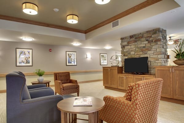 A common area with chairs and a TV