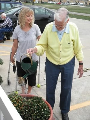 Resident gardening with staff assistance