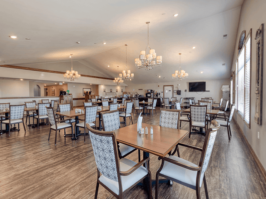 Dining room with tables and chairs, well-lit