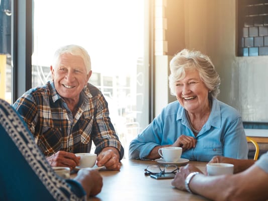Residents enjoying coffee and conversation at a table