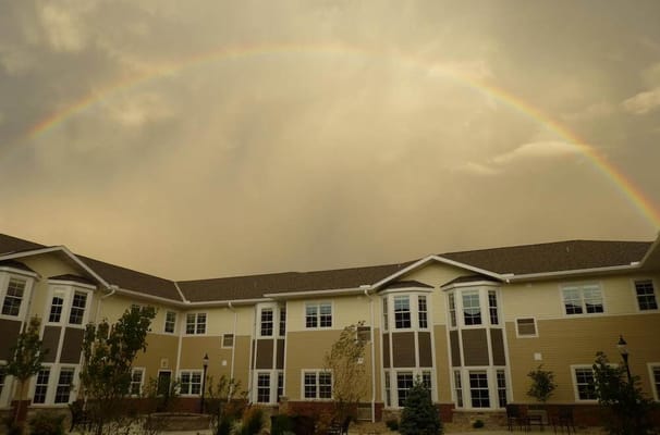 Exterior view of the facility with a rainbow