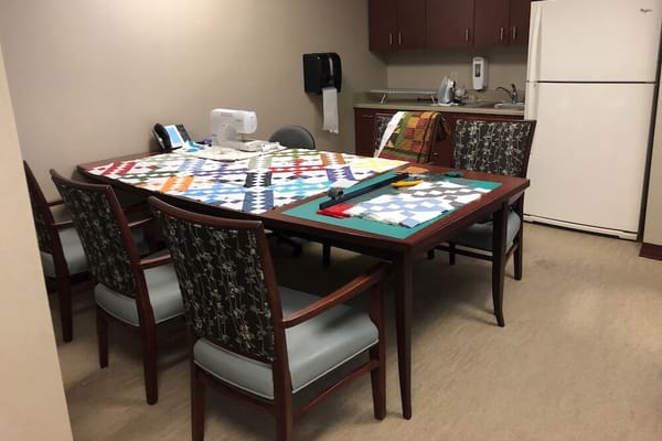 Interior room with a crafting table and chairs