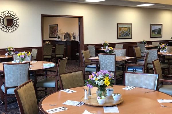 Bright dining room with flowers on round tables