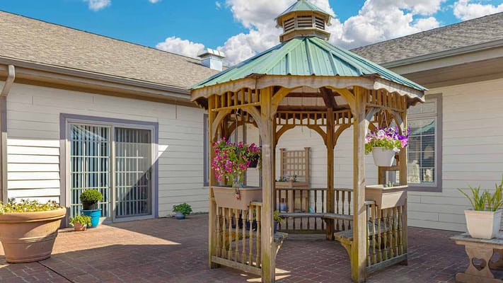 Outdoor gazebo in a landscaped area.