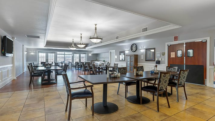 Dining room with tables and chairs in a bright setting