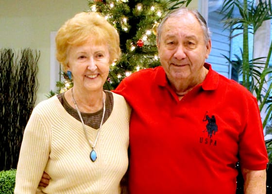 A senior couple smiling together in a festive setting