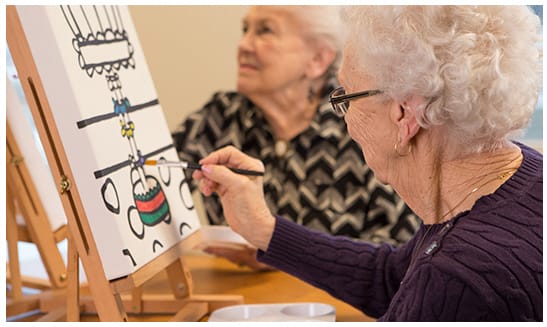 Residents participating in an art activity at a table
