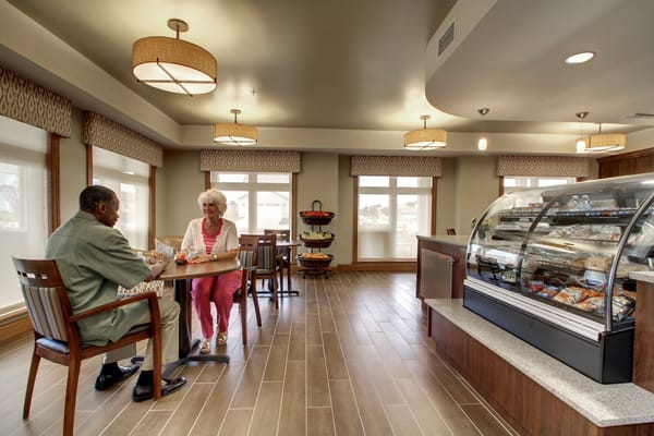 Two residents chatting in a cozy common area