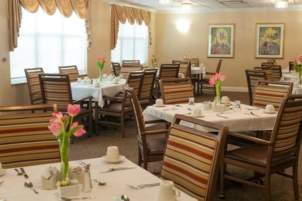 Dining room setup with flowers and table settings