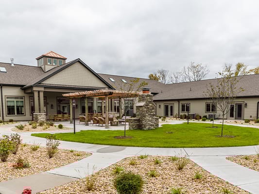 Exterior view of a senior living facility with landscaped gardens