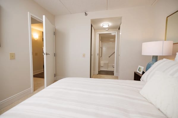 Interior view of a private resident room with a bed and bathroom