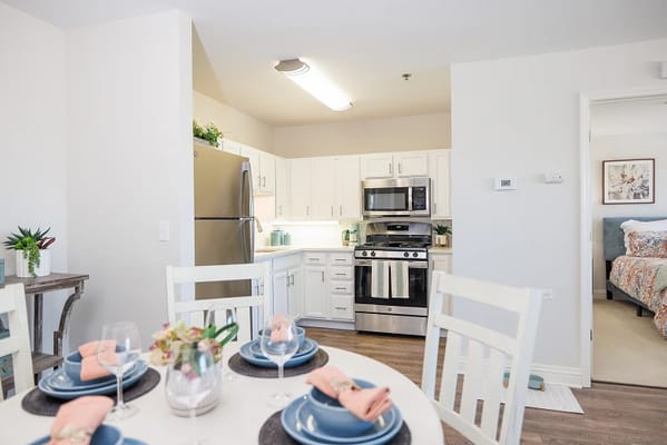 Bright kitchen area with dining table set for a meal