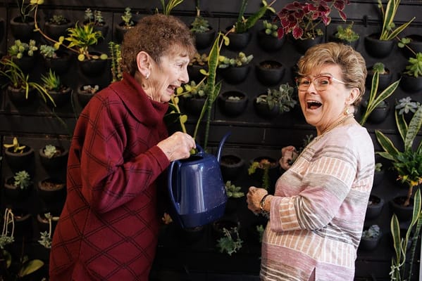 Two residents enjoying a gardening activity indoors