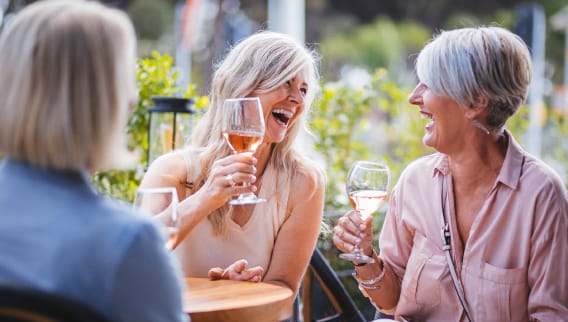Residents enjoying drinks and laughter outdoors