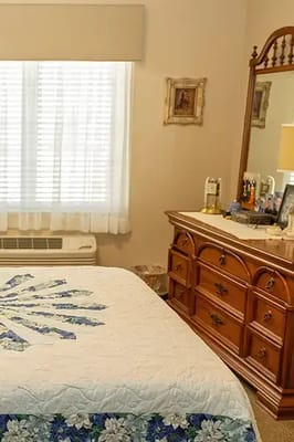 Cozy private resident room with a decorated bed