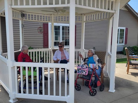 Residents socializing in an outdoor gazebo