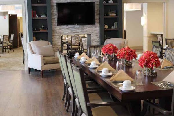 Bright dining room set for a meal with floral centerpieces
