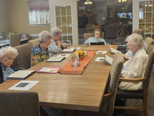 Residents engaged in group activities at a large table