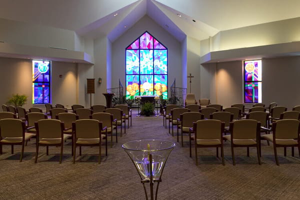 Interior of a chapel with a stained glass window