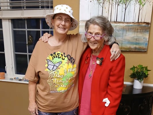 Two residents posing together indoors