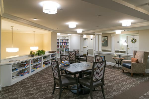 Community lounge area with comfortable seating and bookshelves