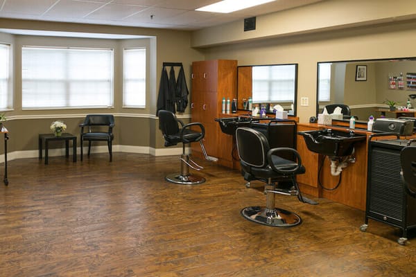 Interior view of a hair salon with chairs and mirrors