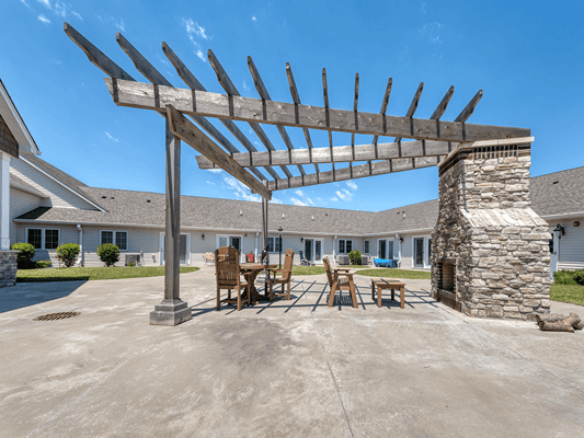 Outdoor pergola area with seating at the facility
