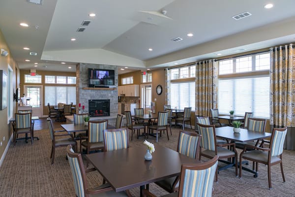 Bright common area with tables and chairs in a cozy setting