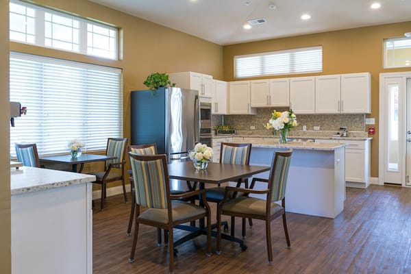 Bright dining area with tables and chairs in a spacious kitchen