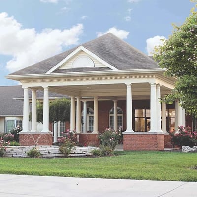 Exterior view of the facility entrance with columns