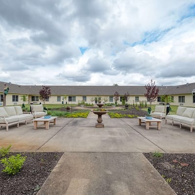 Outdoor seating area with garden and cloudy sky