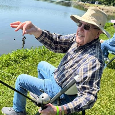 Senior man fishing by the lake enjoying an outdoor activity