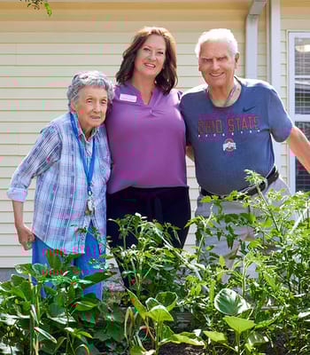 A resident and staff member in a garden