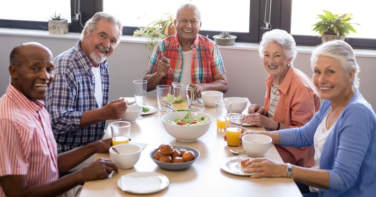 Residents enjoying a meal together in the dining room