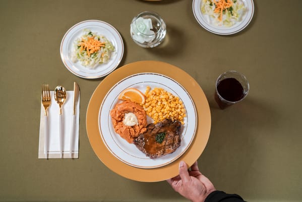 A resident enjoying a meal in the dining room