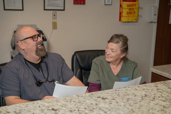 Staff members discussing at the reception desk