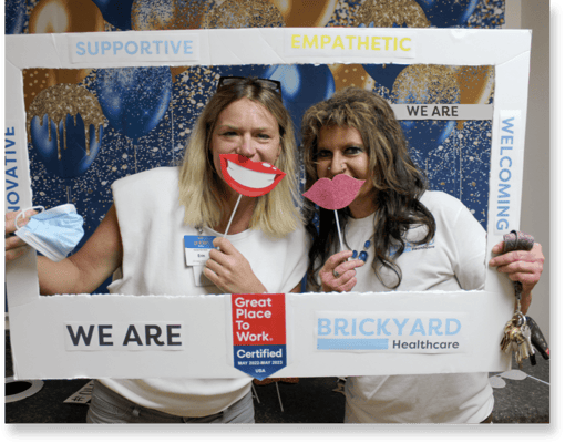 Staff members celebrating with photo props at an event