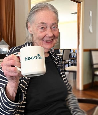 Resident enjoying coffee in a cozy interior