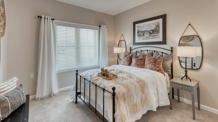 Brightly decorated resident bedroom with natural light