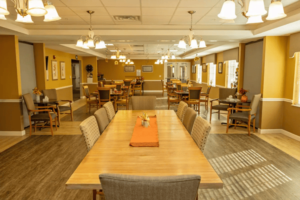 Bright dining room with tables and chairs for residents