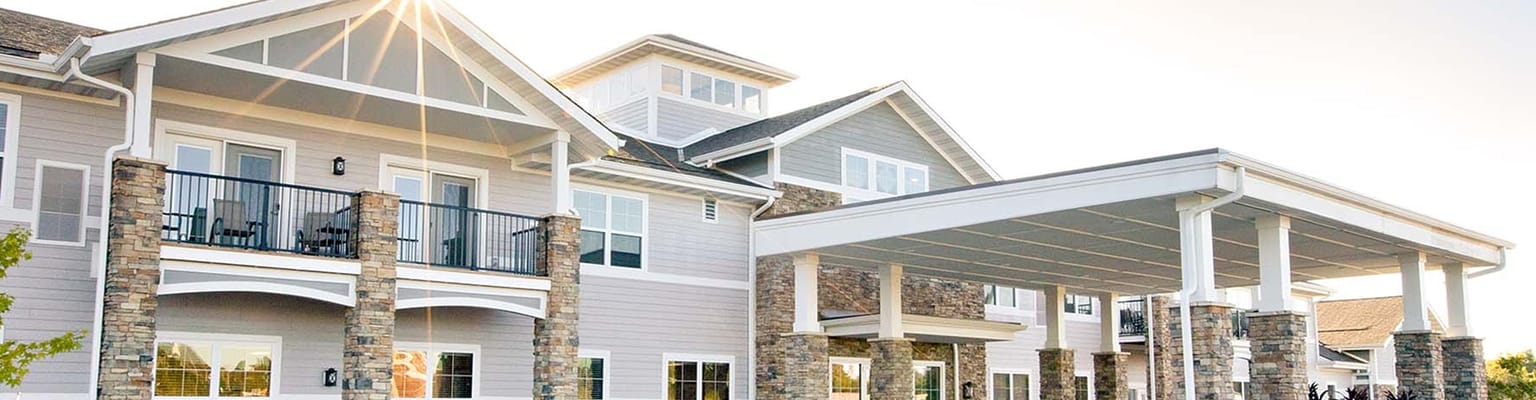 Exterior view of a senior living facility with outdoor space
