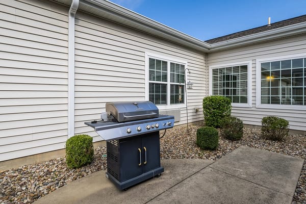 Outdoor barbecue grill area with landscaping